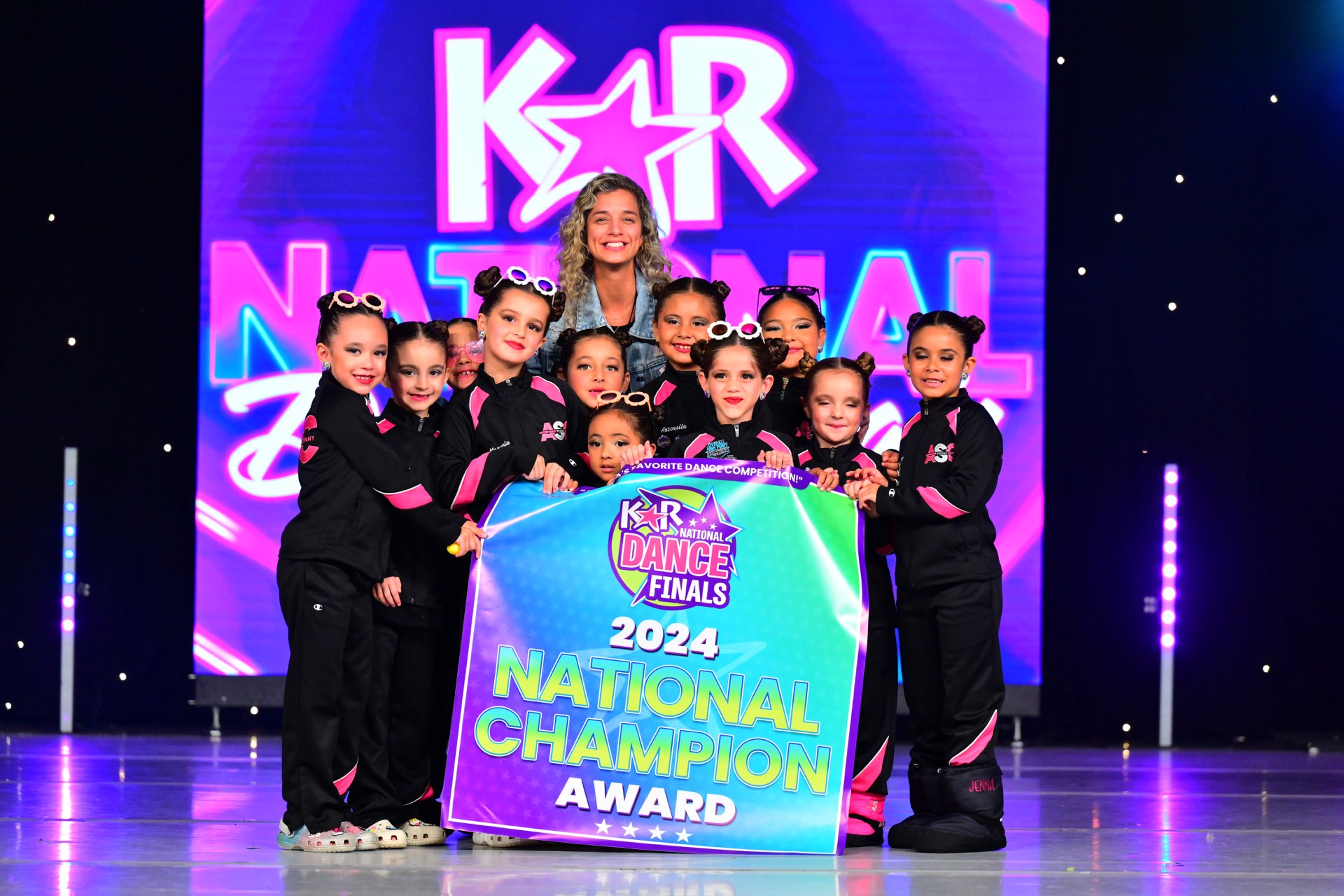Mini and Petite Apprentice dancers with their national champion banner